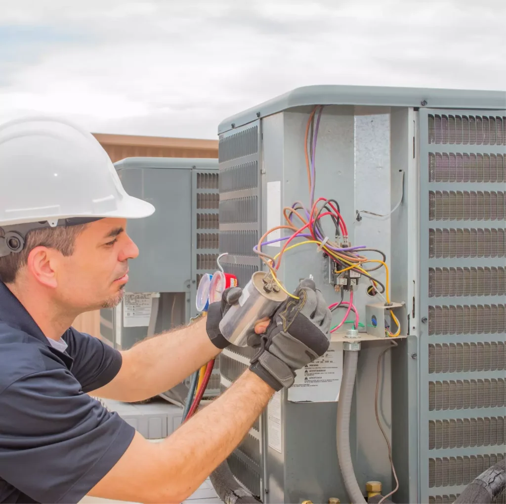 An HVAC technician performing ac repair.