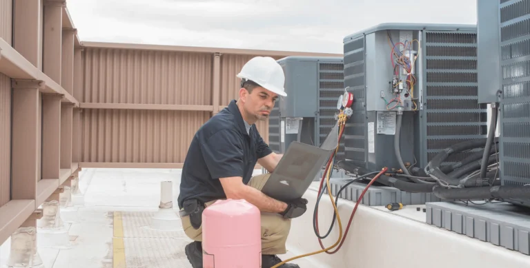 Air Conditioning repair technician fixing a unit in Victoria, TX