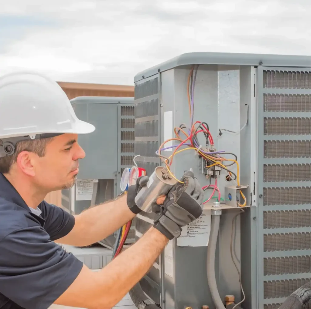 An HVAC technician performing ac repair.