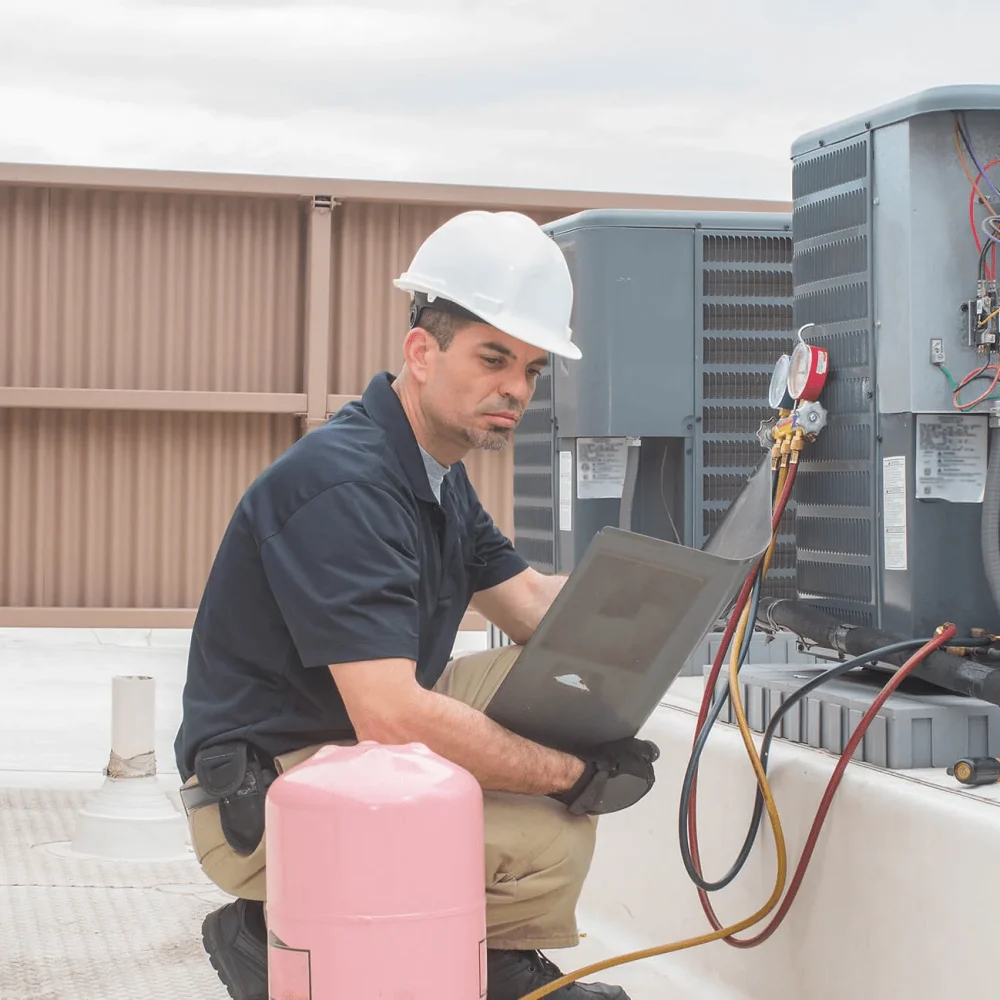 Air Conditioning repair technician fixing a unit in Victoria, TX